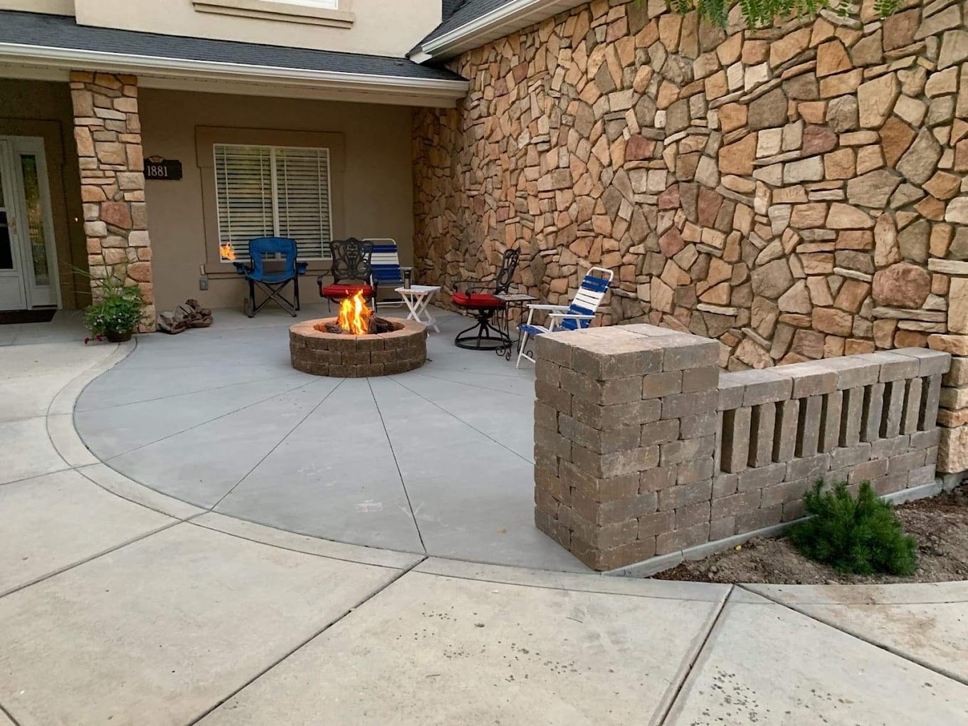 Concrete patio with stone fireplace