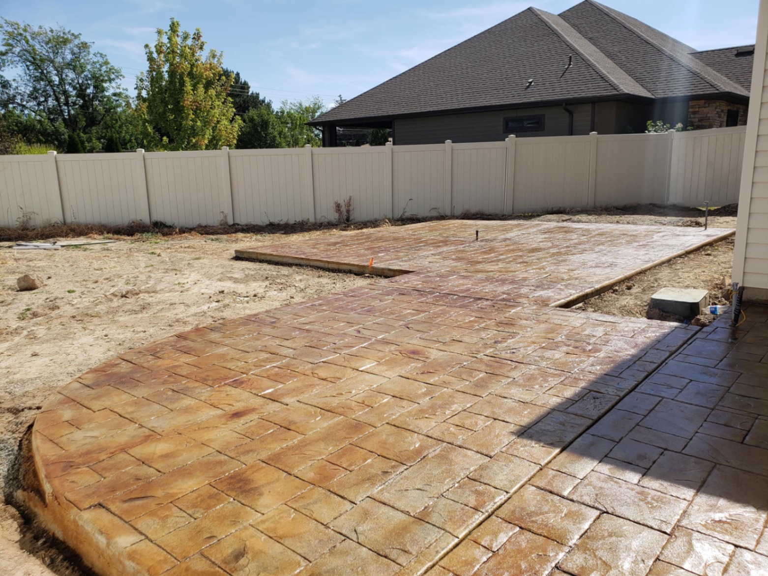 Stamped concrete walkway with earth-tone stain